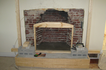 A fireplace being built in the process of being installed.