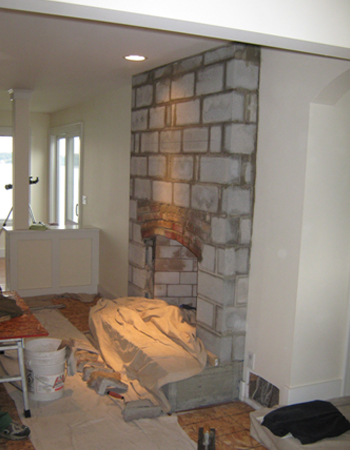 A room with a fireplace and walls in it