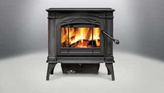 A black fireplace with fire burning inside of it.