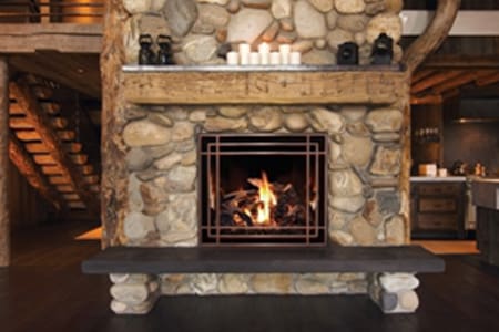 A fireplace with candles and rocks in it