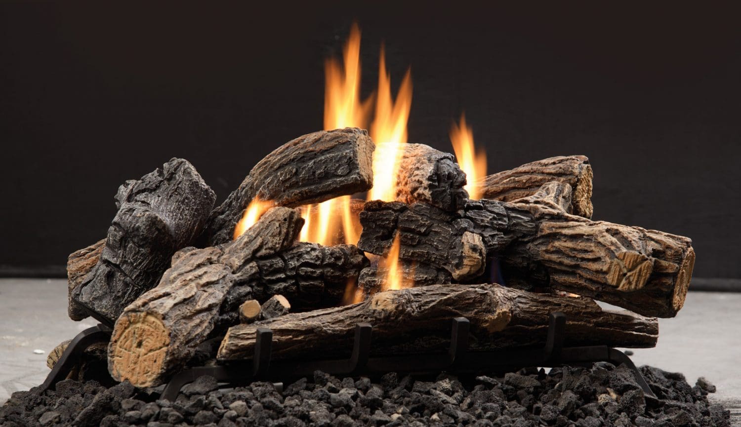 A fire burning in the fireplace of an outdoor room.